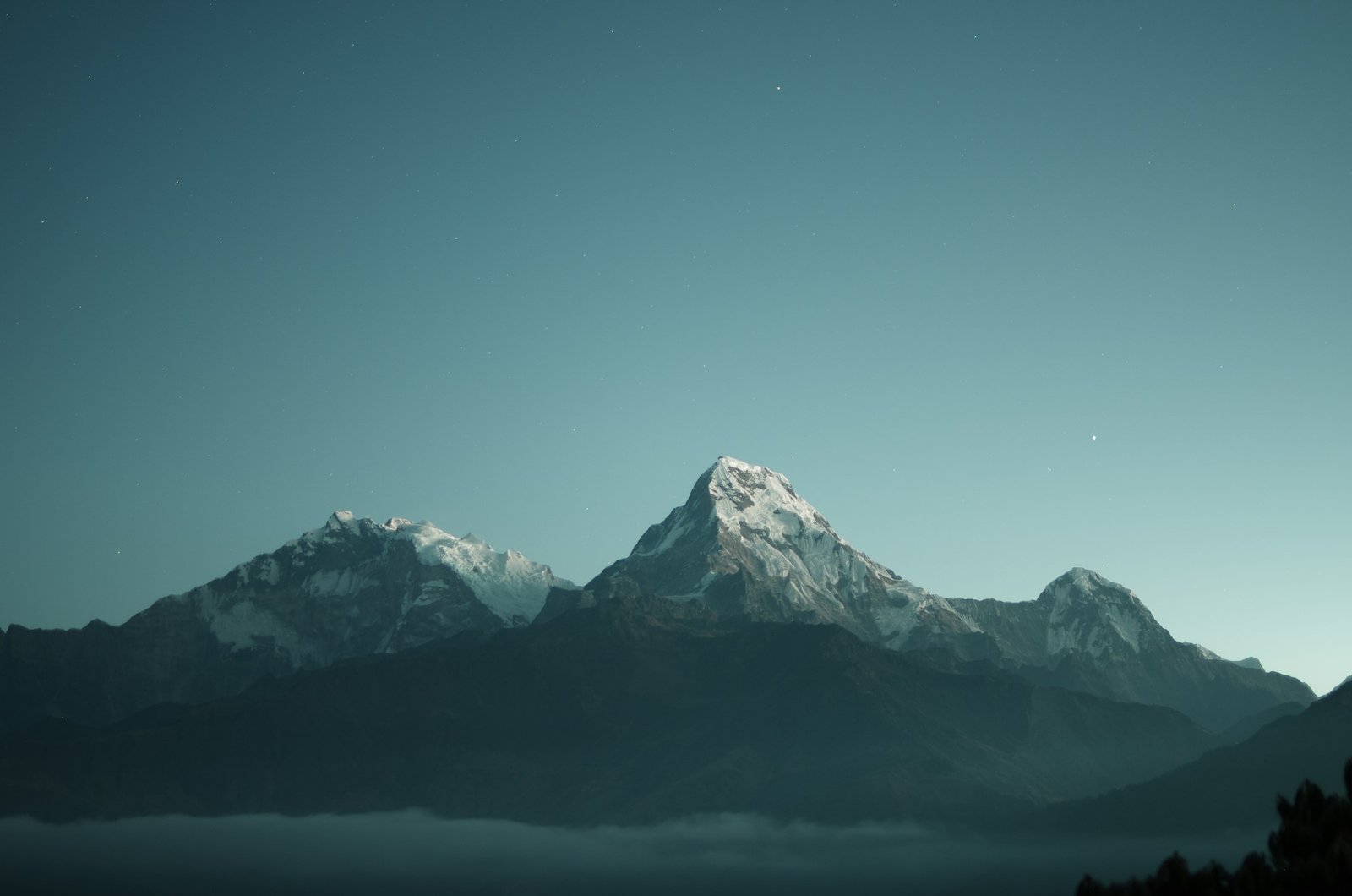 Snow-capped peak at altitude — the firm's standard.